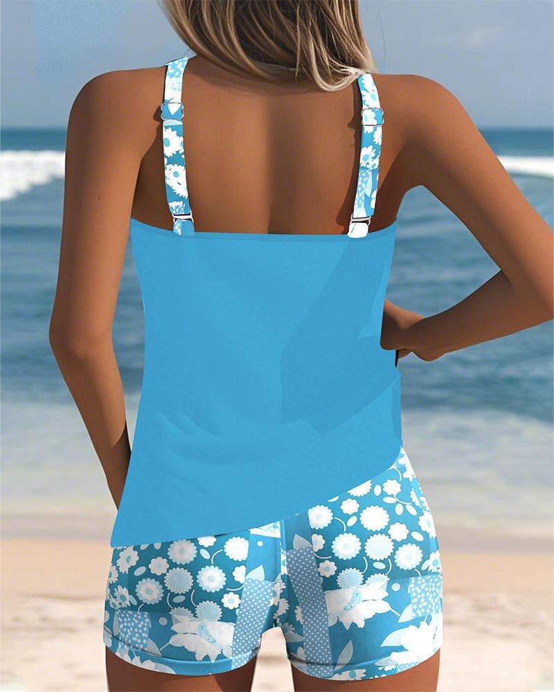 Back view blue swimsuit tank top with printed boxer shorts and white floral strap trim