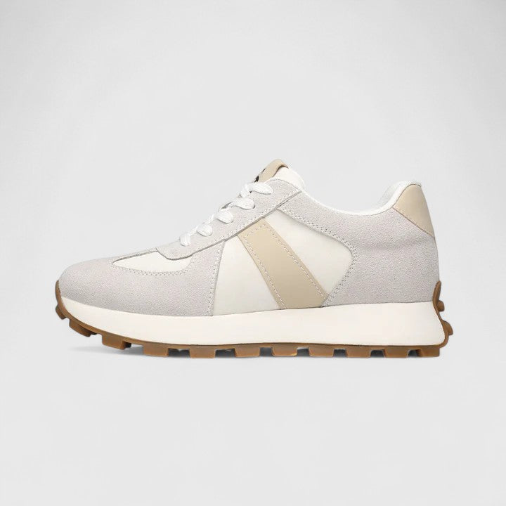 White lace-up sneakers with beige stripe panels and brown rubber tread sole