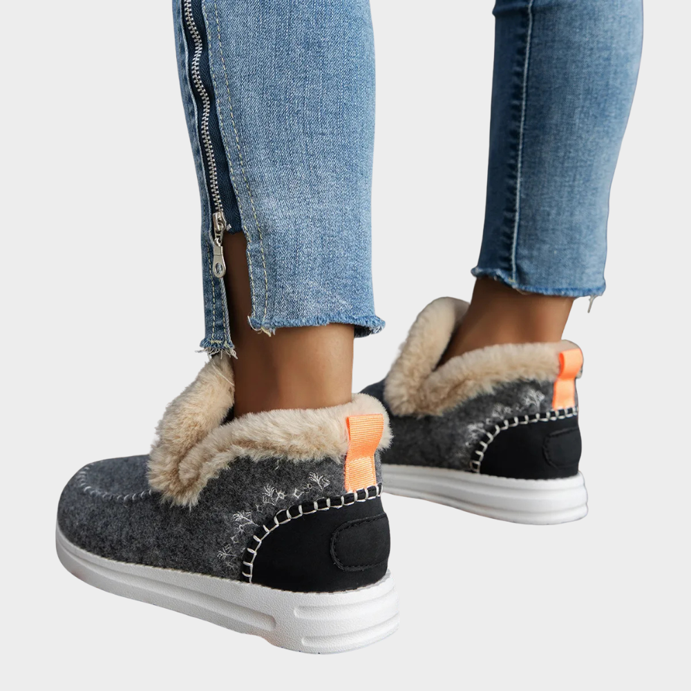 Cozy slip-on boots in dark grey with faux-fur trim, orange pull tabs, white stitching