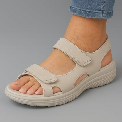 Beige orthopaedic sandals with two hook-and-loop straps and thick ridged sole