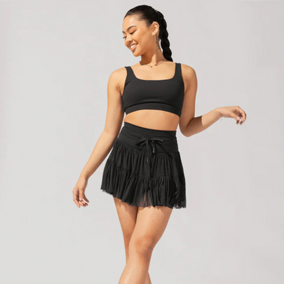 Black high-waist pleated skort with drawstring waist and tiered ruffle skirt