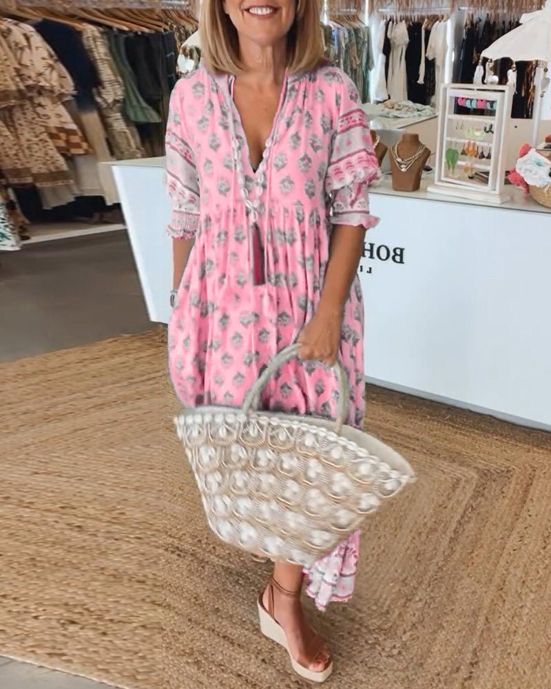 Pink floral V-neck maxi dress with ruffled sleeves and tiered hem, side view