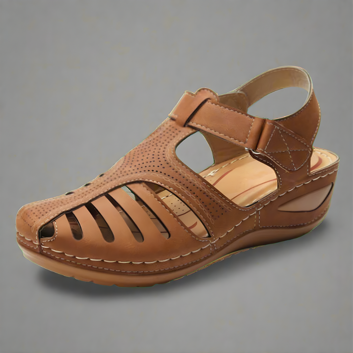 Orthopedic bunion corrector sandal, tan leather-look with perforated quarter and strap.