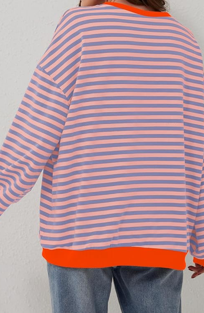 Striped sweater with peach and purple horizontal stripes, orange ribbed hem and cuffs