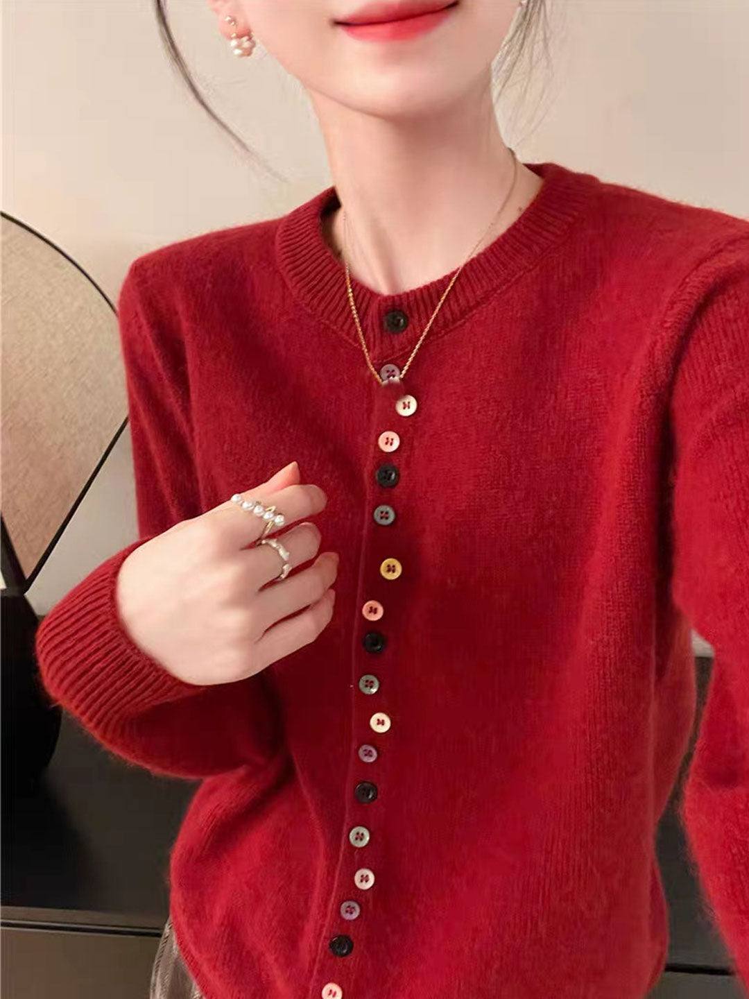 Red knit cardigan with button front and ribbed collar, relaxed long sleeves