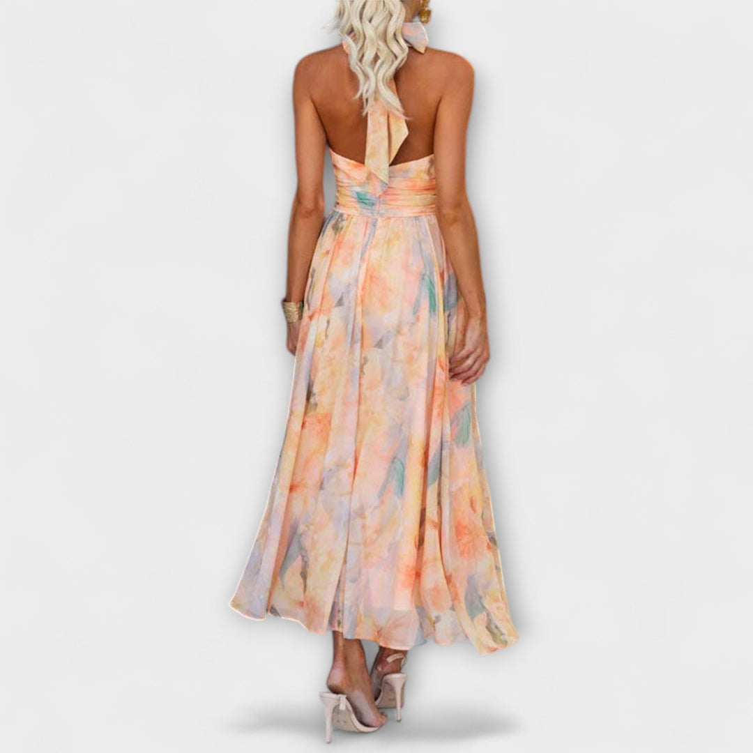 Maxi dress back view: halter tie, sleeveless pastel floral print, gathered waist
