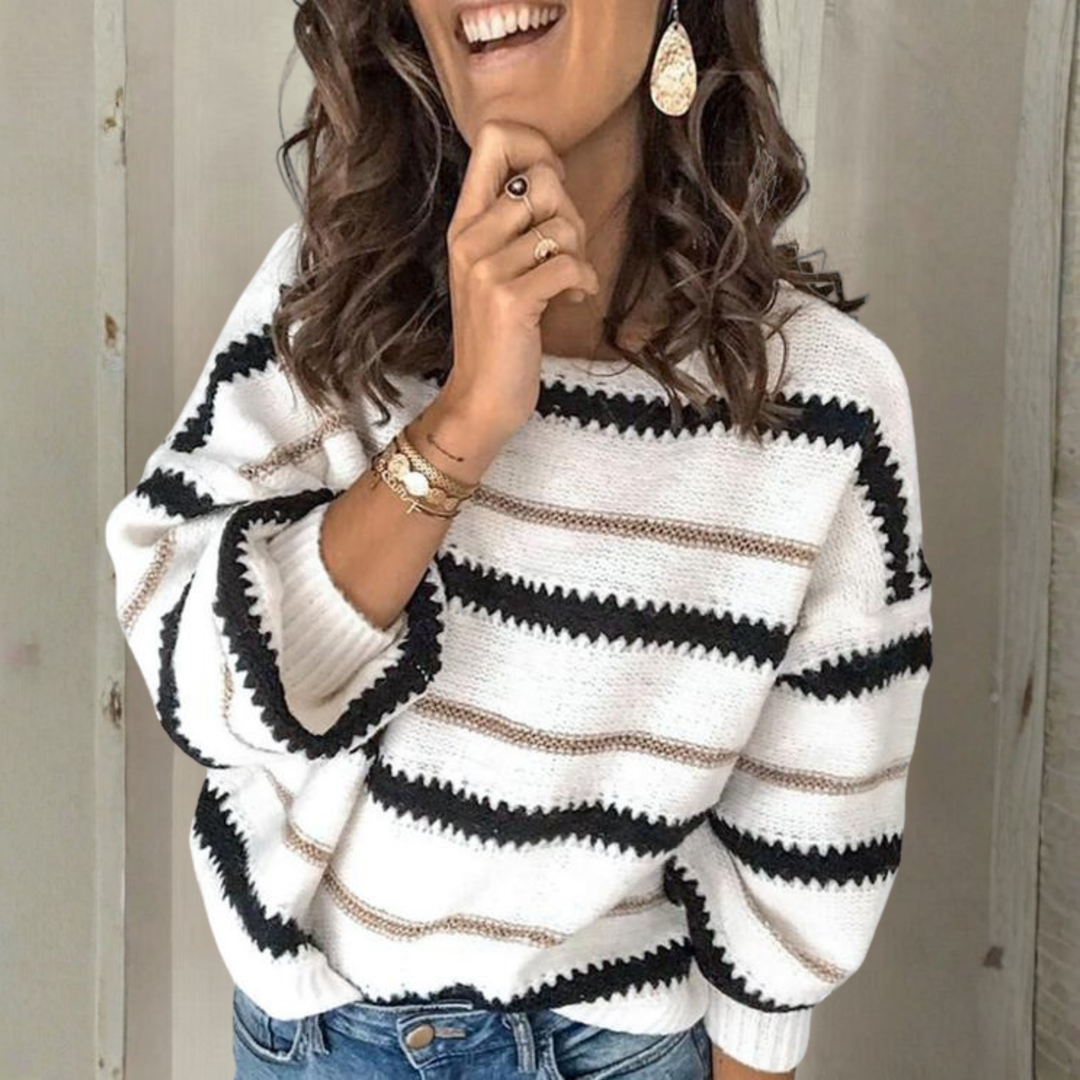 Crewneck sweater with long sleeves; white knit with black and tan horizontal stripes.