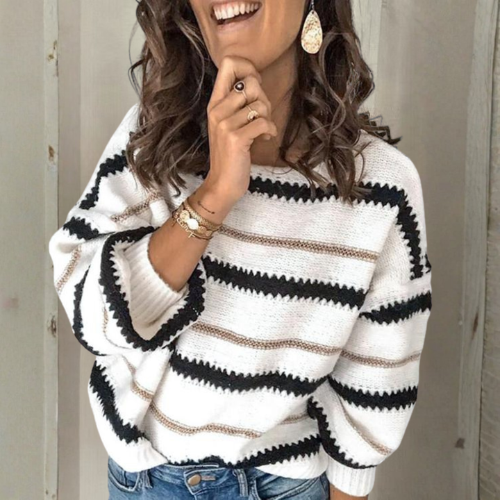 Crewneck sweater with long sleeves; white knit with black and tan horizontal stripes.