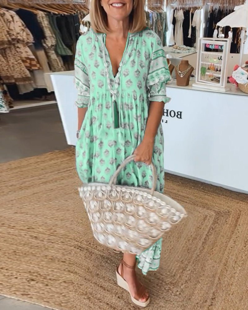 Green floral V-neck dress with tassel-front neckline and tiered ruffled skirt