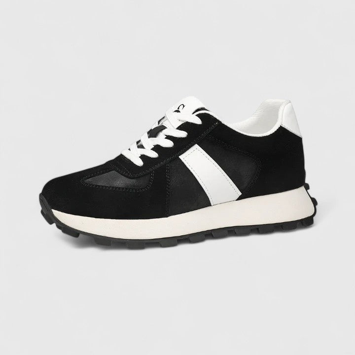 Black lace-up sneakers with white side panel and thick white rubber tread sole