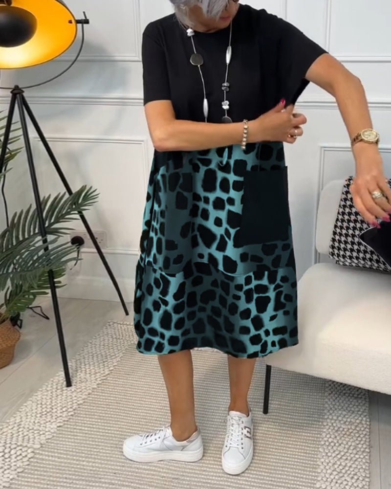 Women's black midi dress with teal leopard print panel, short sleeves, relaxed A-line