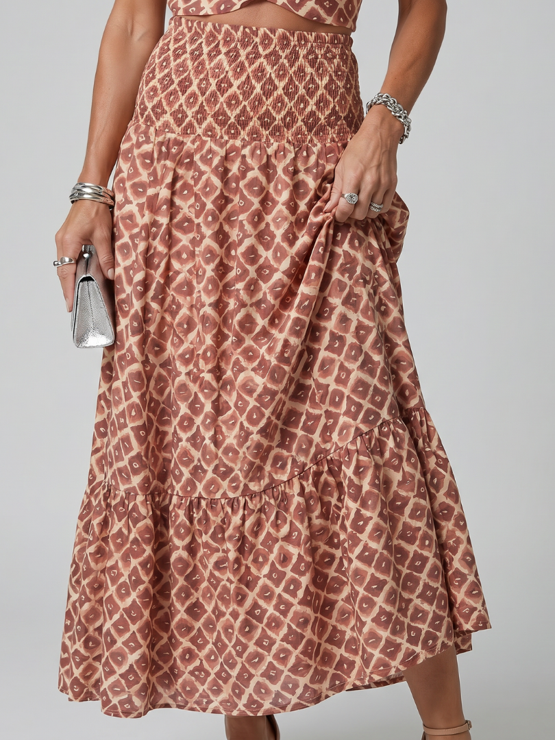 Dusty rose geometric print tiered midi skirt with gathered smocked waist and ruffle layers