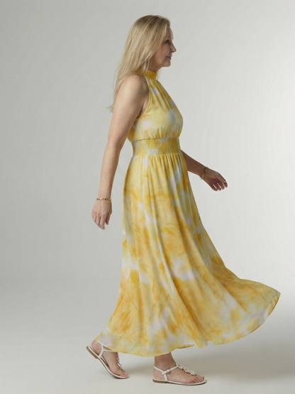 Yellow gathered halter midi dress, side view, smocked waist and tiered skirt