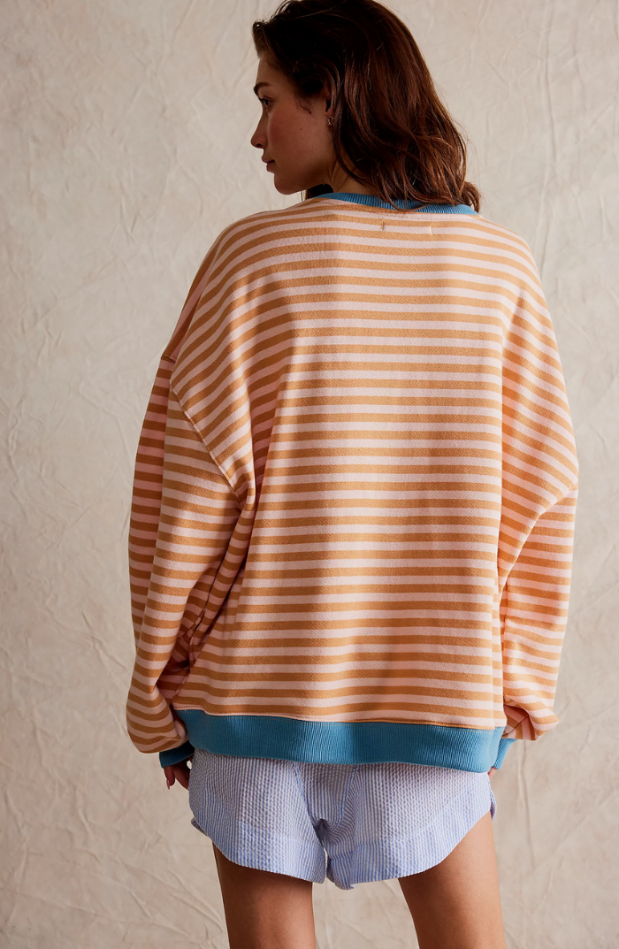 Striped sweater in tan and brown horizontal stripes, teal ribbed cuffs and hem