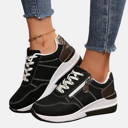 Orthopedic shoes in black with white laces, brown/bronze heel and toe caps