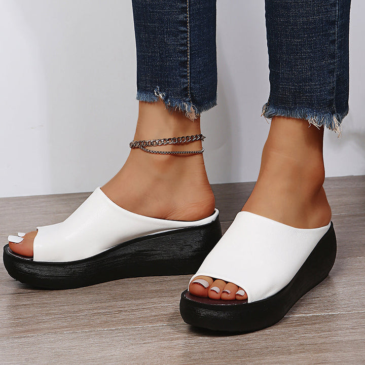 White orthopedic slide sandals with wide open toe and thick black platform sole