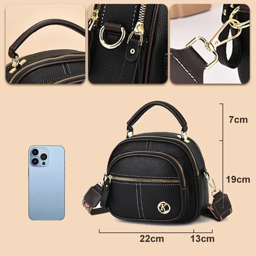 Black mini crossbody shoulder bag with gold-tone hardware, crossbody strap, and zip closure