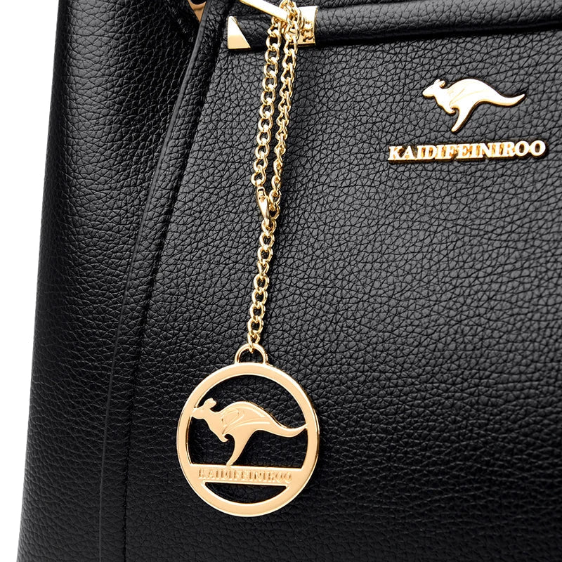 Vaeni women’s handbag detail, black pebbled leather with gold kangaroo logo and round charm