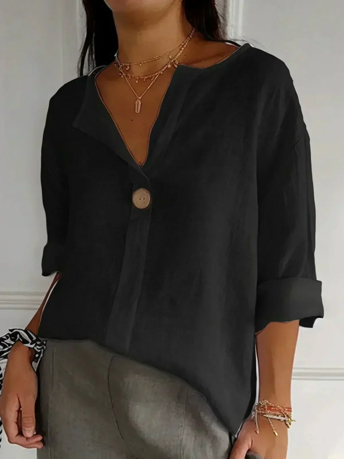 Black V-neck blouse with button front and elbow-length sleeves