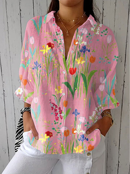 Pink floral print blouse with 3/4 sleeves and button-up neckline
