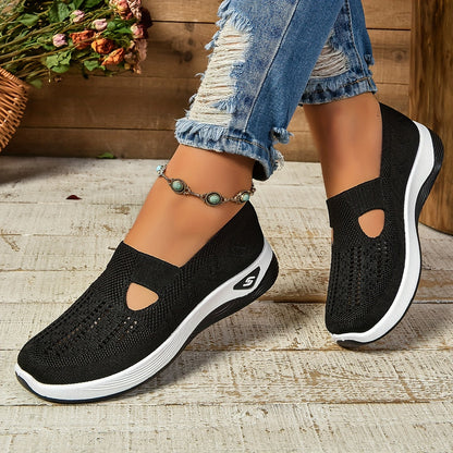 Black orthopedic slip-on shoes, knit upper with cutout sides and cushioned white sole