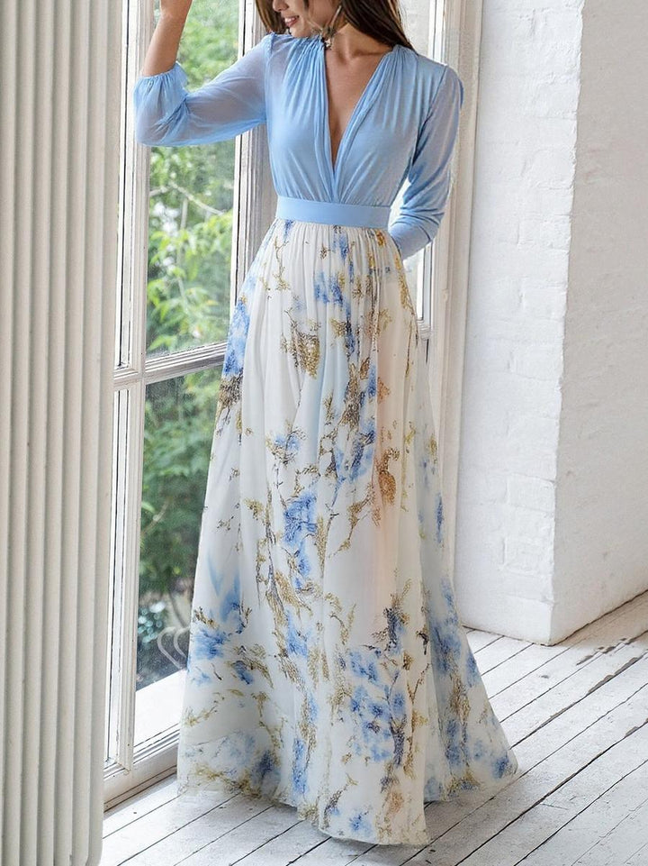 Floral maxi dress with light blue long sleeves, V-neck bodice, and pleated skirt