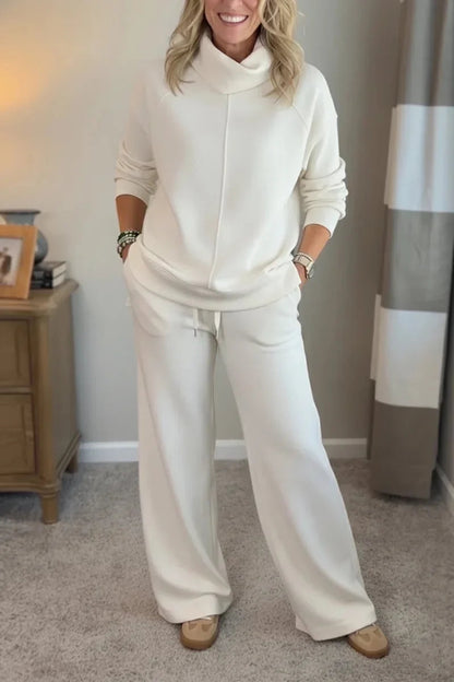 White coordinated zip-front hoodie top and wide-leg pants set.
