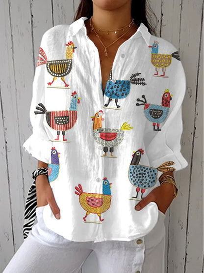 White button-front blouse with long sleeves, playful multicolor bird appliques