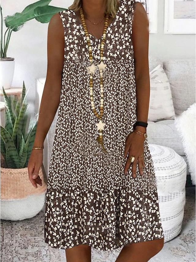 Sleeveless V-neck floral dress, dark base with small white blossoms, gathered hem