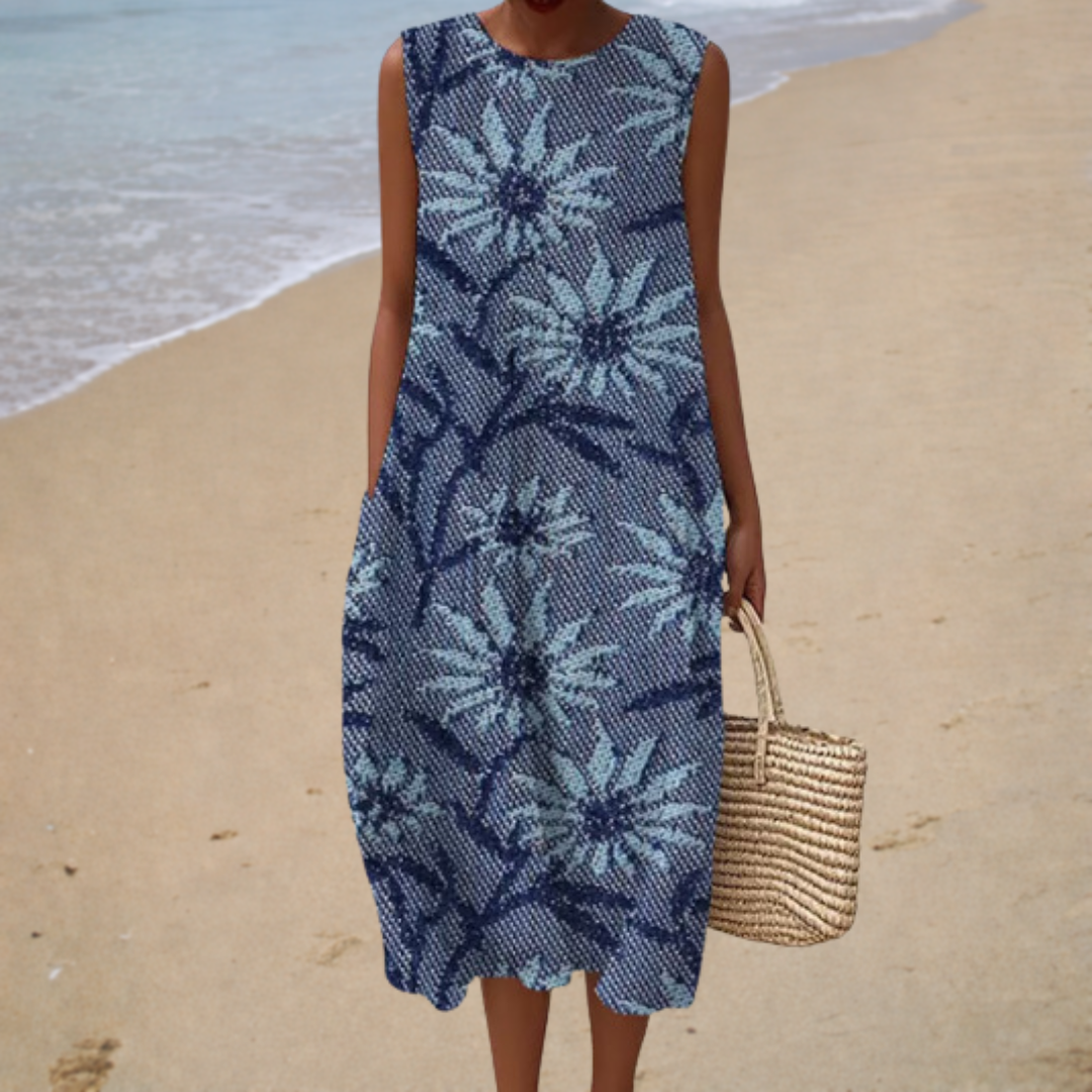 Sleeveless summer dress in blue with white daisy floral print, round neckline and midi length