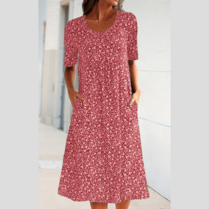 Floral summer dress in pink with short sleeves and scoop neckline, midi length