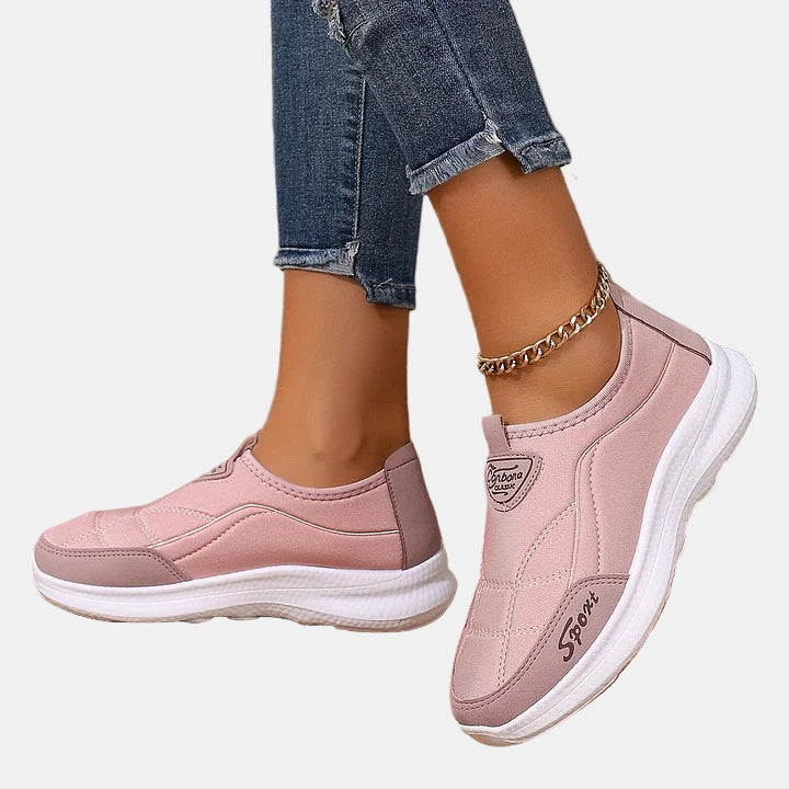 Pink slip-on sneakers with cushioned sole and side stitching detail
