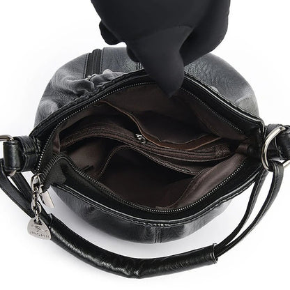 Black handbag interior view with main zipper opening and stitched inner compartments
