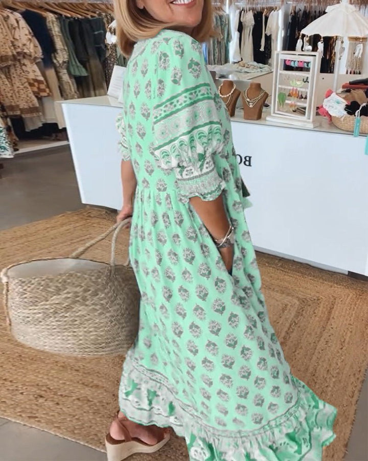 Green floral V-neck dress with ruffle-trim hem and patterned yoke