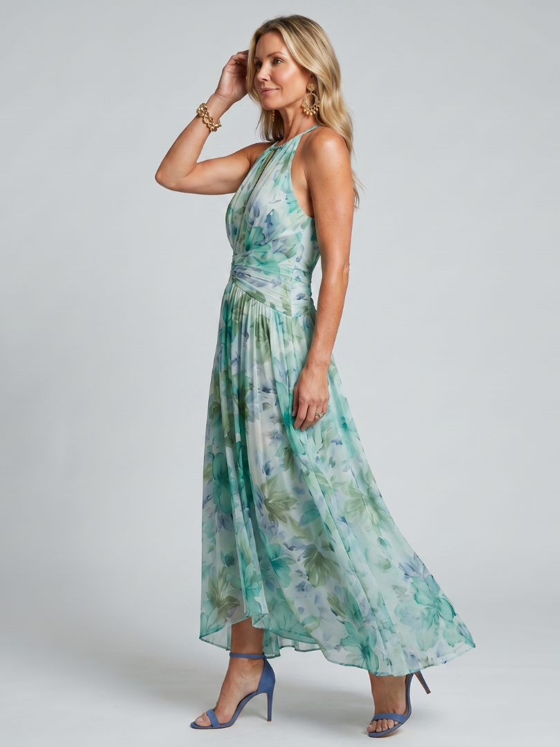 Green halter midi dress with pleated skirt and soft floral print, side profile