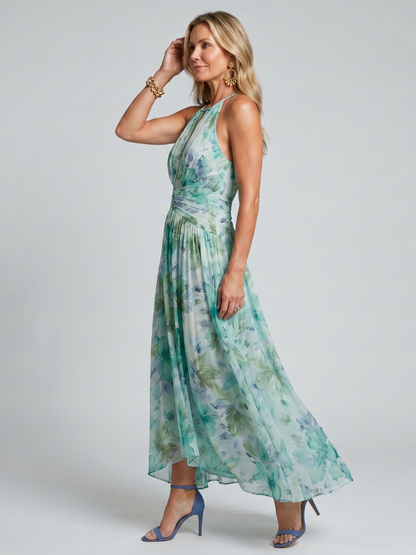 Green halter midi dress with pleated skirt and soft floral print, side profile