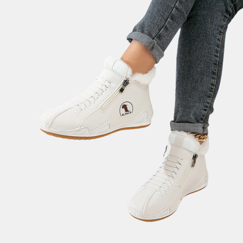 White ankle boots with faux fur trim, side zipper, lace-up front, and tan rubber sole.