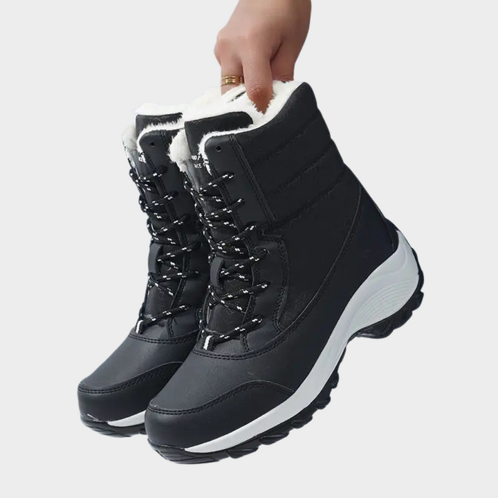 Black winter boots with lace-up front, padded collar, and white faux-fur lining.