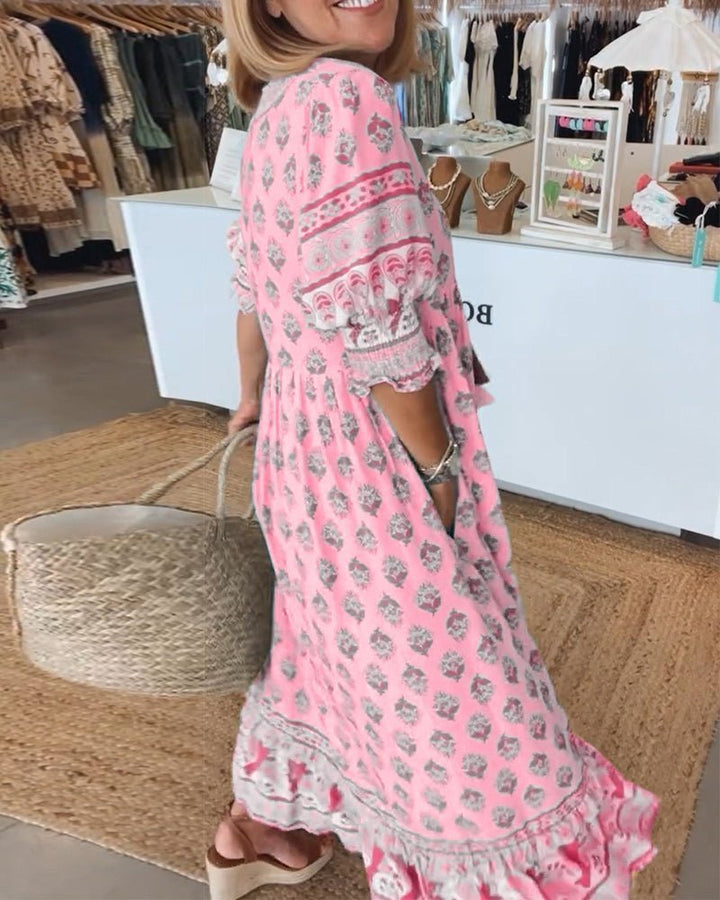 Pink floral V-neck dress with short flutter sleeves and ruffle-trim hem