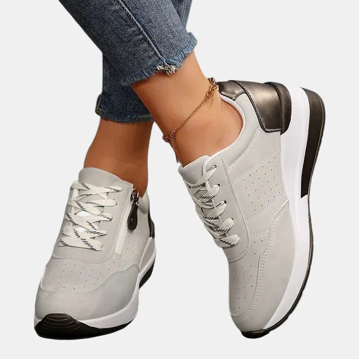 Orthopedic shoes in white with white laces, bronze heel accent and chunky sole