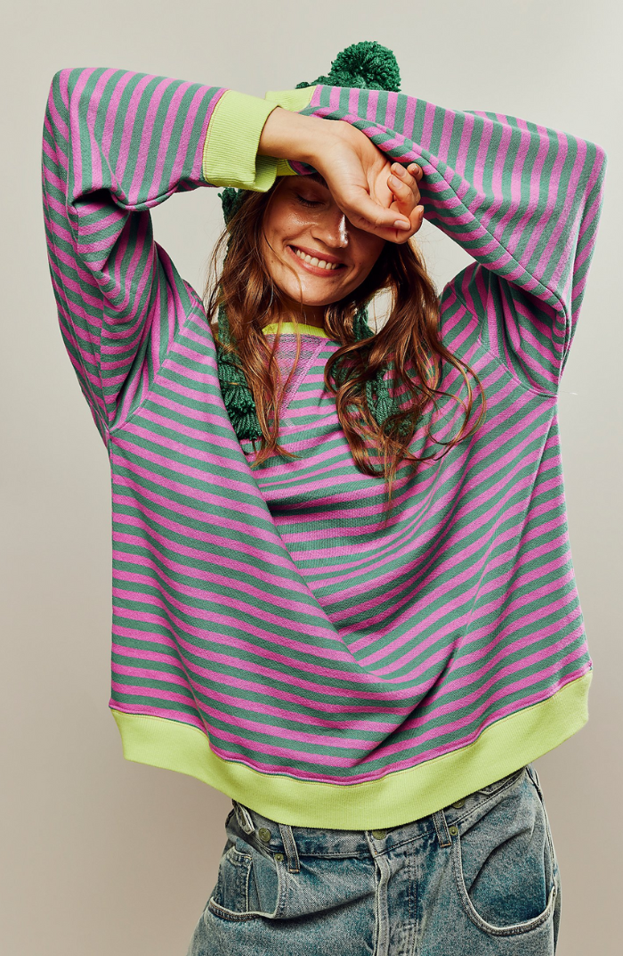 Striped sweater with green and pink horizontal stripes, ribbed cuffs and lime-green hem