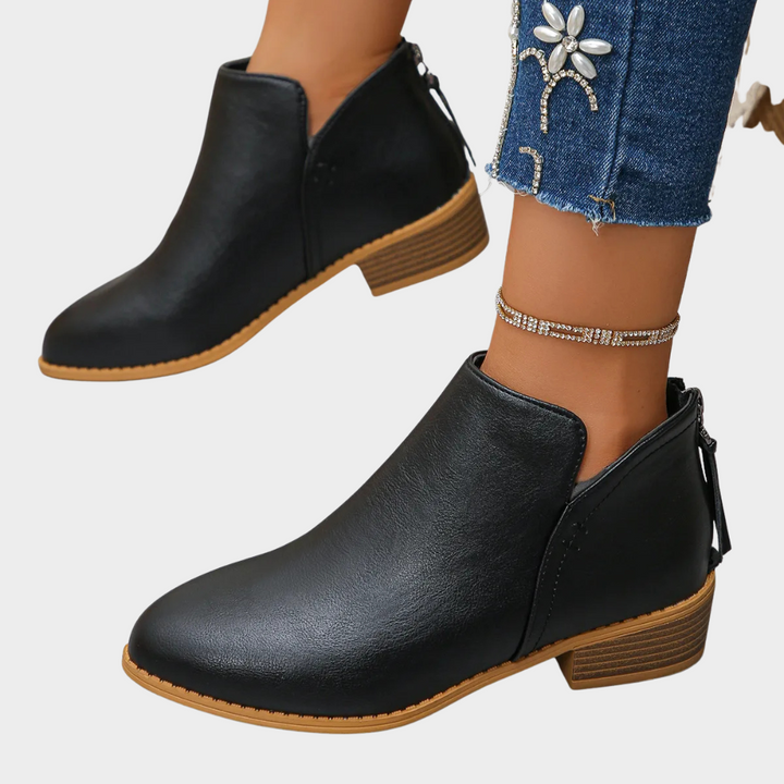 Black low-heel ankle boot, side view with tan sole and lace-up detail
