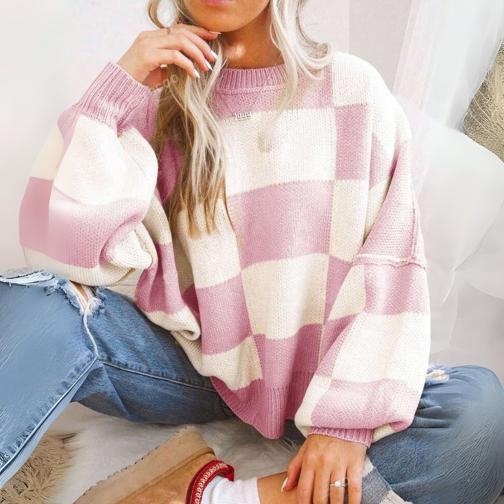 Pink and white checkered crewneck long-sleeve knit sweater with ribbed cuffs