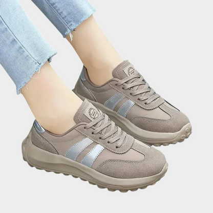 Gray lace-up orthopedic sneakers with light blue stripe detail and cushioned sole