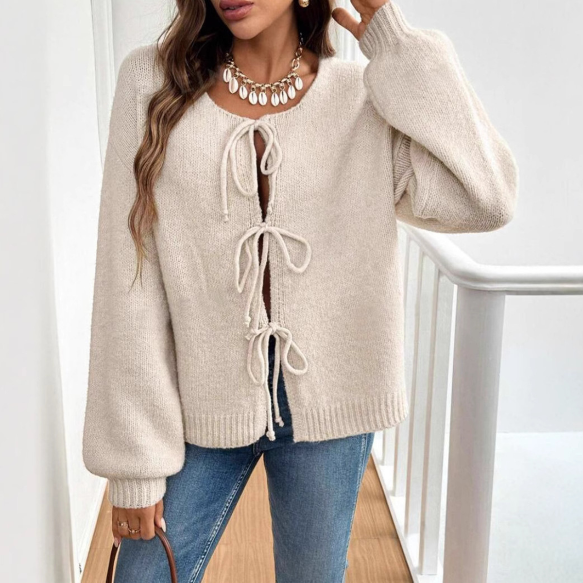 Off-white tie-front cardigan with round neck and drawstring lacing, long sleeves