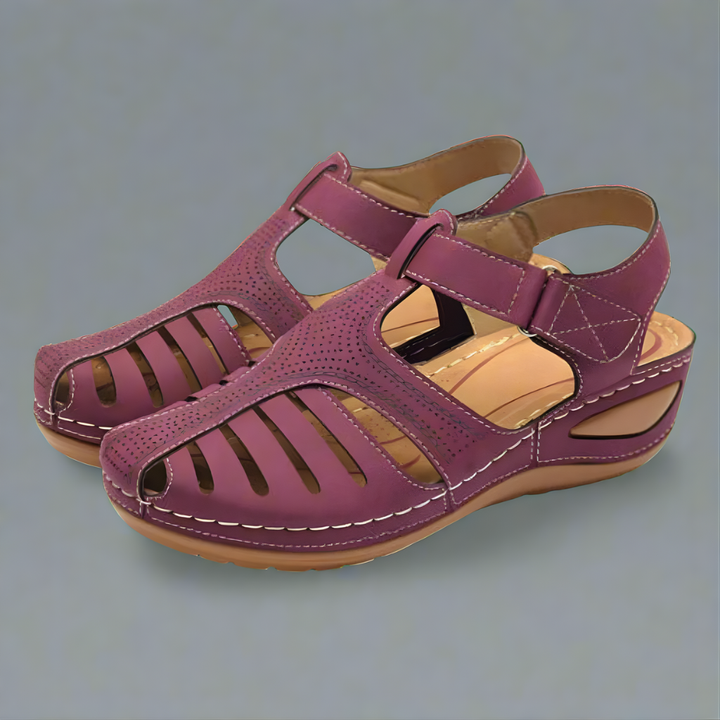 Orthopedic bunion corrector sandal, burgundy leather-look with adjustable buckle straps.