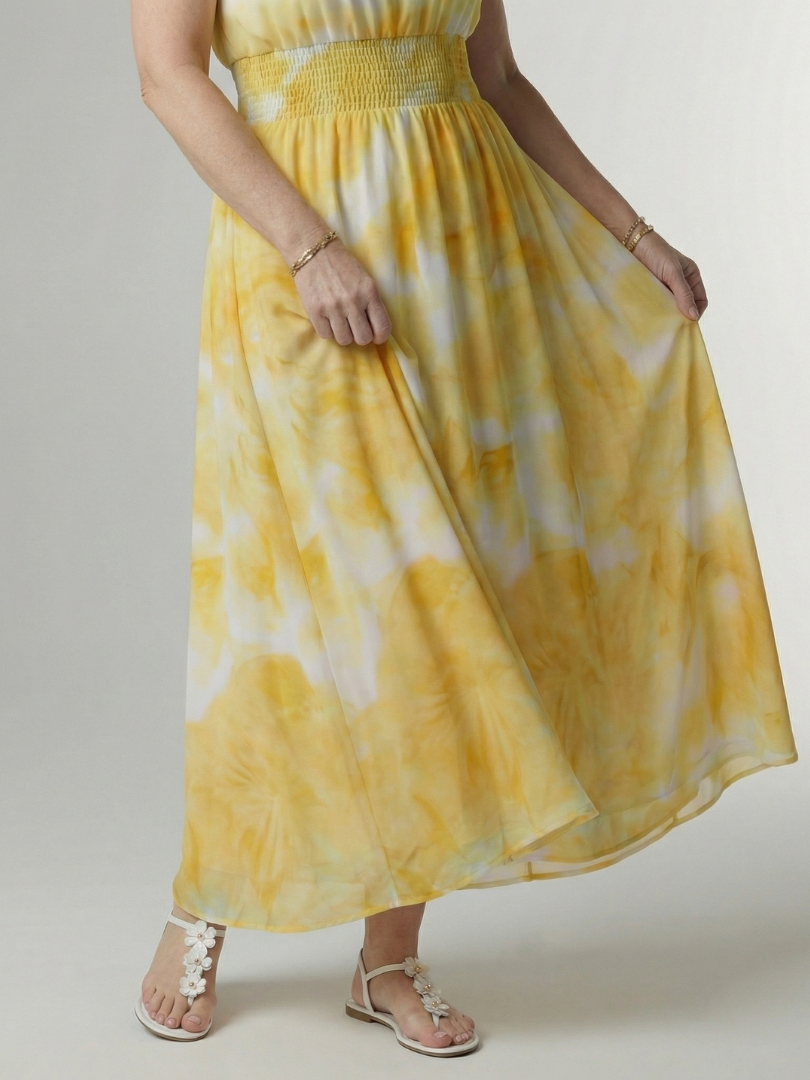Yellow gathered halter midi dress close-up of smocked waist and skirt