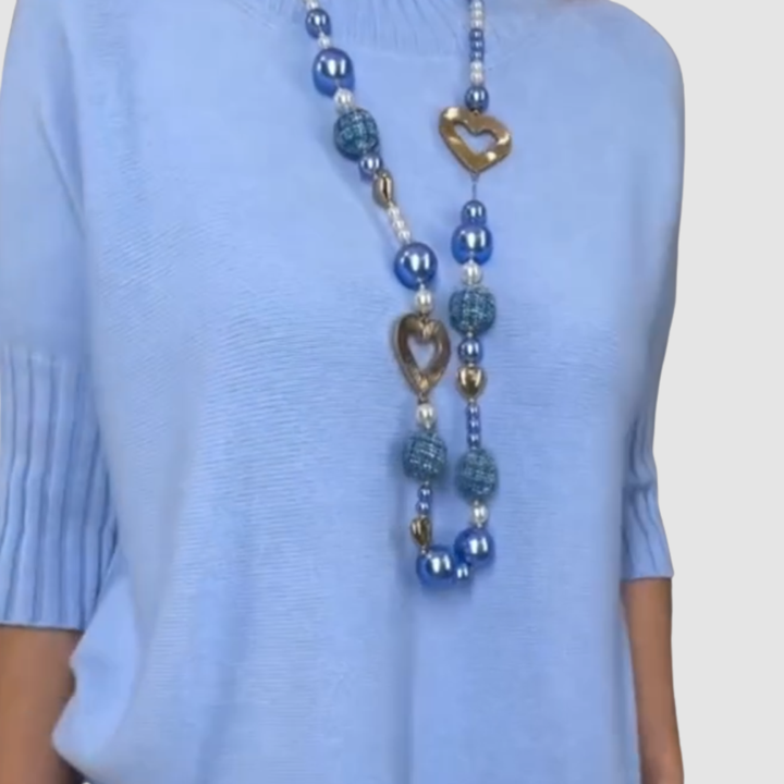 Blue knit top with layered heart pendant beaded necklace