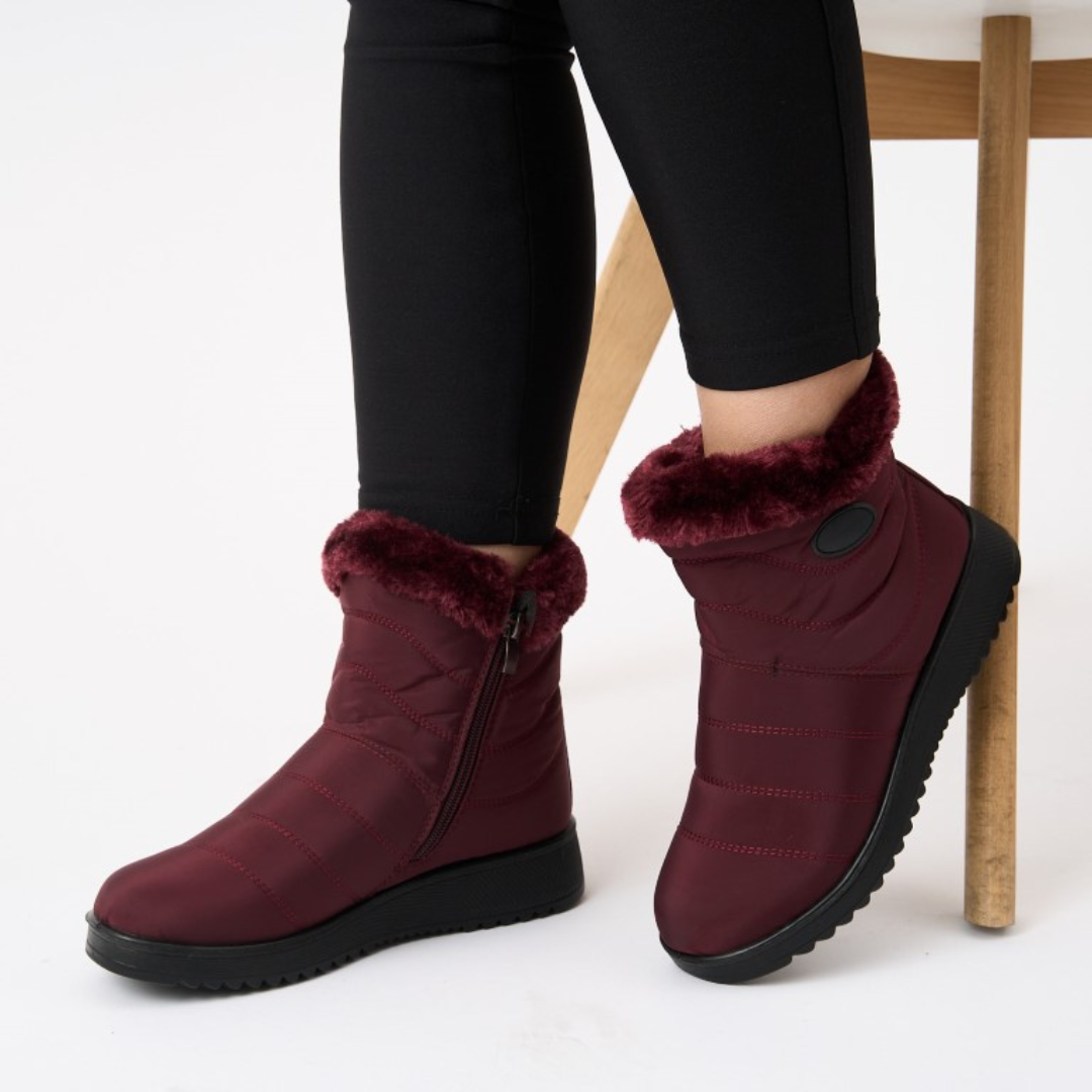 Pair of burgundy/red waterproof ankle boots with faux fur lining and side zip