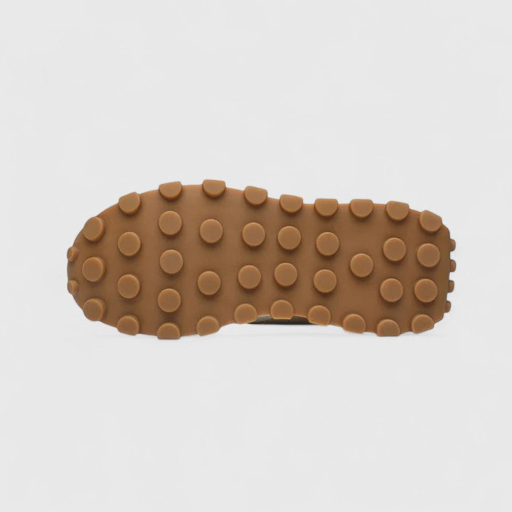 Tan rubber outsole with round tread bumps for grip